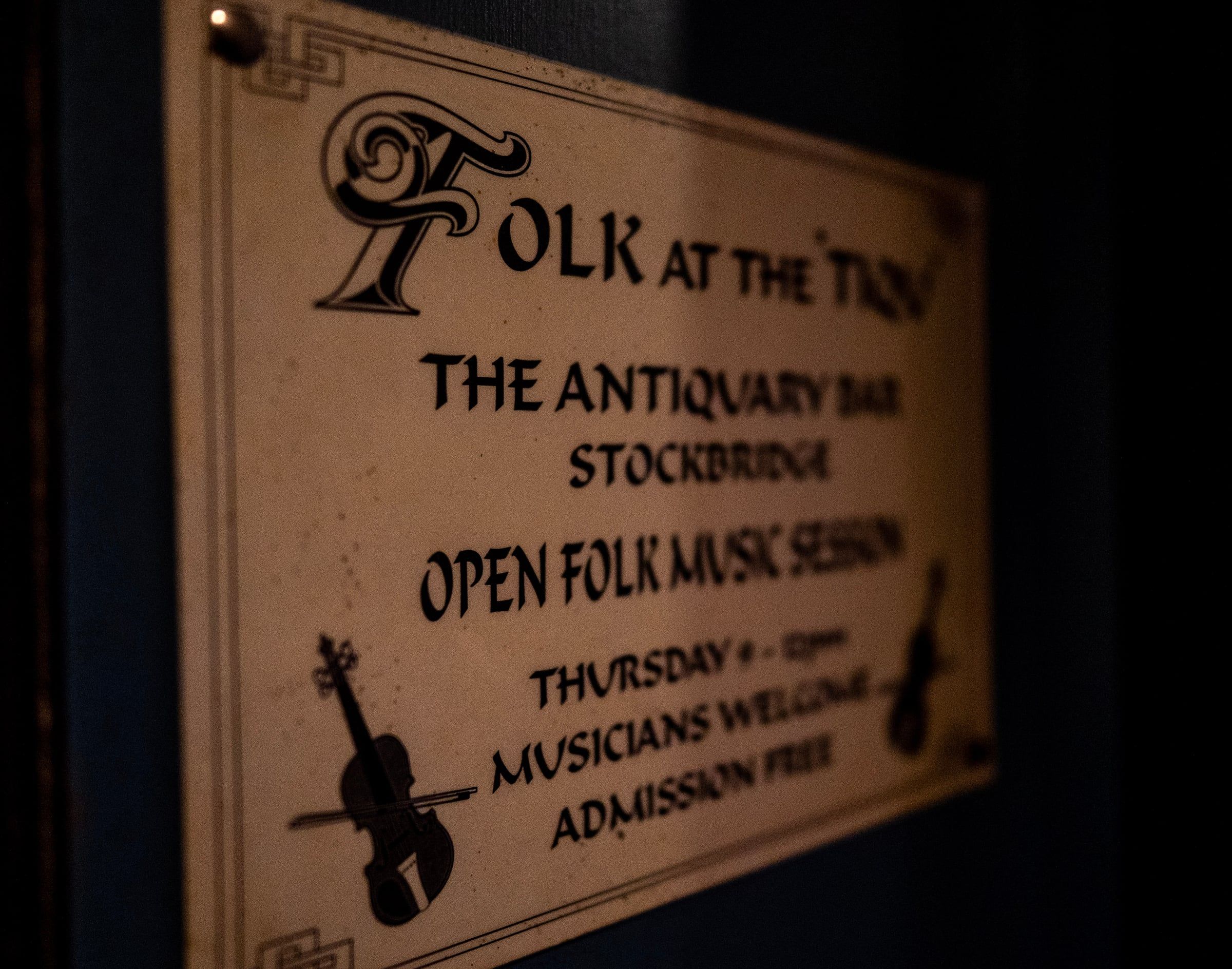 The Folk at the ’Tiq sign