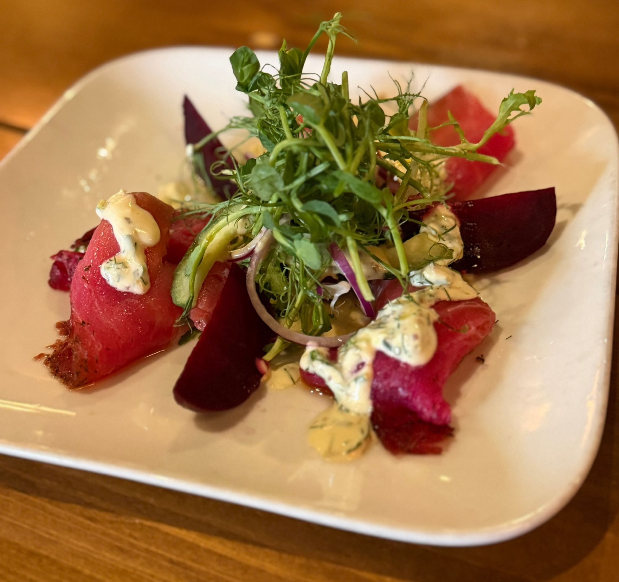 Beetroot cured gravadlax with pea shoots, cucumber and a dill dressing