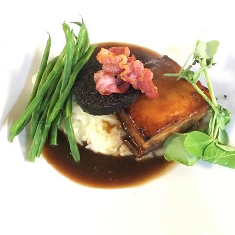 A plate from the kitchen with mash, greens and gravy